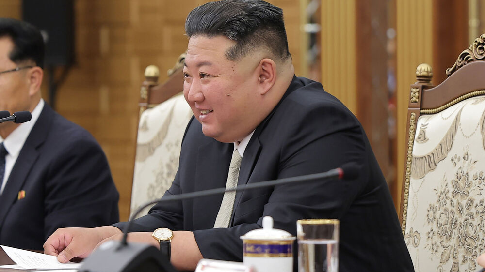 In this photo provided by the North Korean government, North Korean leader Kim Jong Un meets with Chinese President Xi